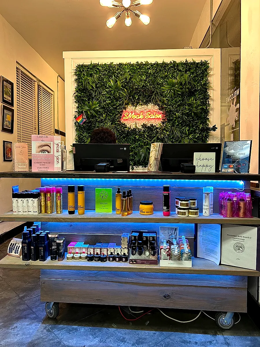 Retail wall of professional hair care products at Smoak Salon